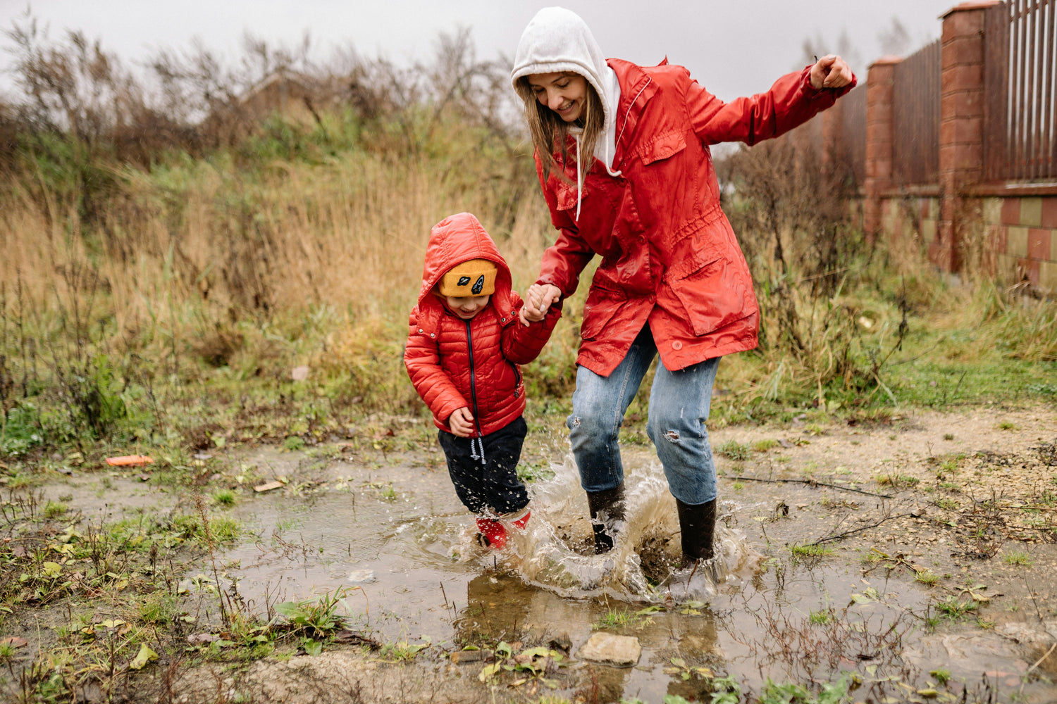 Mom_and_child_jumping_in_puddle